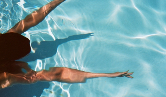 Top shot of a woman floating on the pool