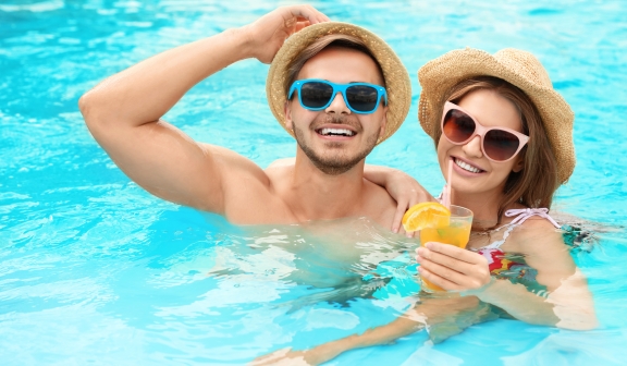 Couple in the pool with a drink