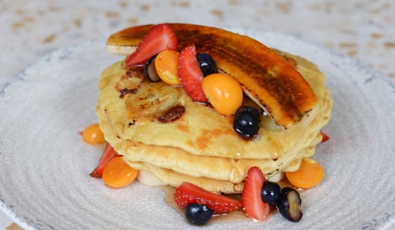 Pancakes topped with fruits served in Birdie's Diner.