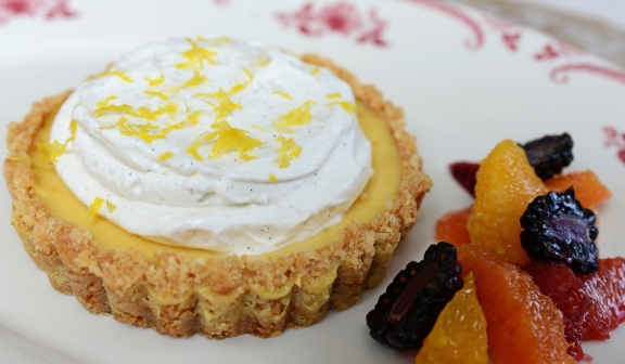 Creamy Lemon Pie topped with lemon zest and served with candied fruits at PGA National Resort.