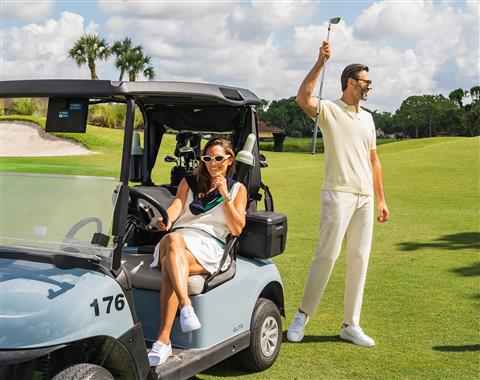 A man and women playing golf