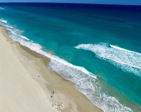 A wide landscape shot of the beach