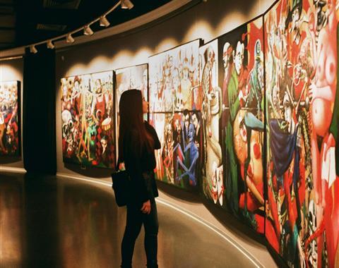 Woman staring at paintings