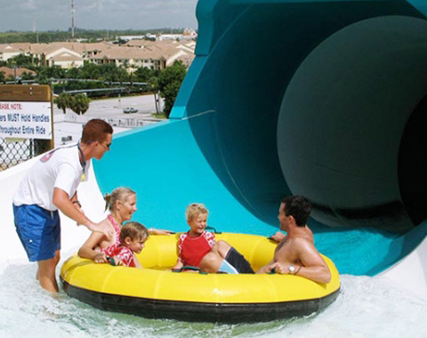 A family about to go down a waterslide