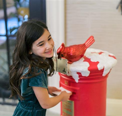 little girl sending a letter to Santa