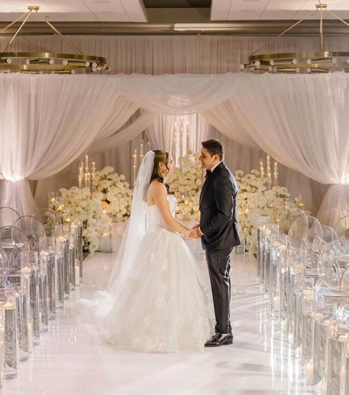 Couple standing at the end of an aisle