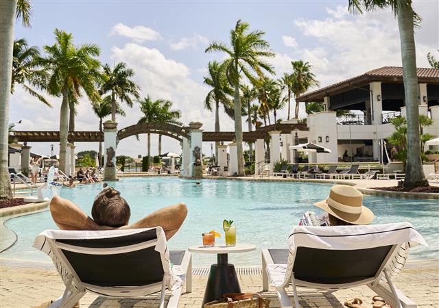Couple lounging by the resort pool