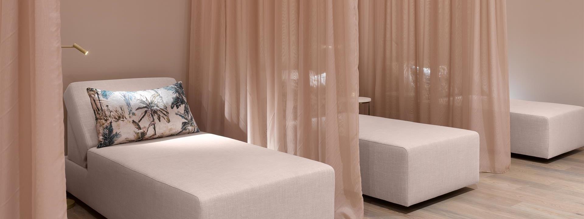 Spa beds with gauzy privacy curtains